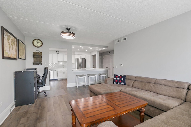 4210 N Natchez Ave Unit 208, Chicago, IL 60634 - living room with wood finished floors, a desk, and a textured ceiling