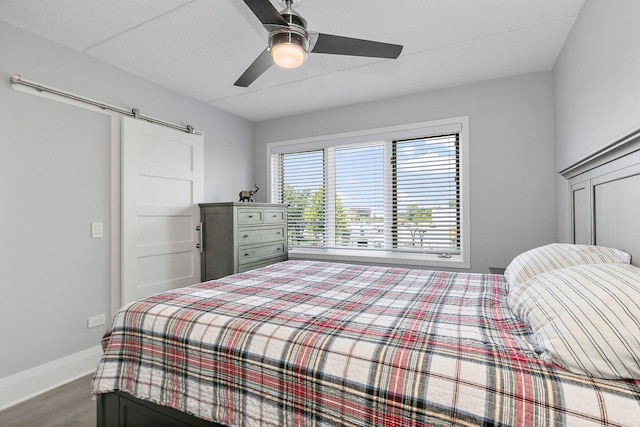 4210 N Natchez Ave Unit 208, Chicago, IL 60634 - bedroom featuring wood finished floors, a barn door, and ceiling fan