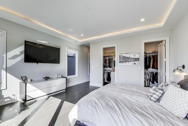 2131 W Huron St, Chicago, IL 60612 - bedroom with a spacious closet, a tray ceiling, recessed lighting, a closet, and wood finished floors