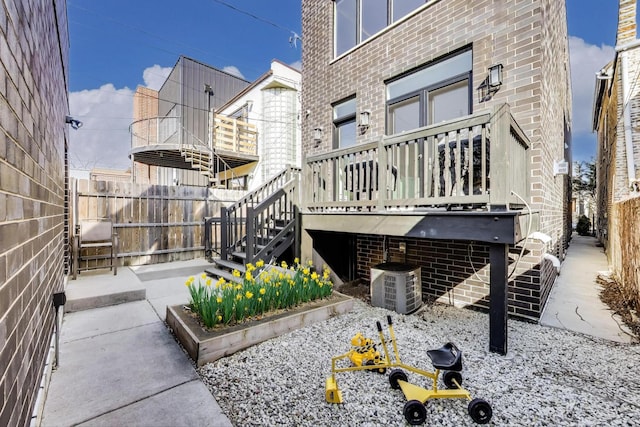 2131 W Huron St, Chicago, IL 60612 - view of side of property featuring stairway, brick siding, and a wooden deck