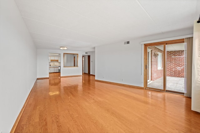 8540 W Foster Ave Unit 505, Norridge, IL 60706 - unfurnished living room with light wood-style flooring and baseboards