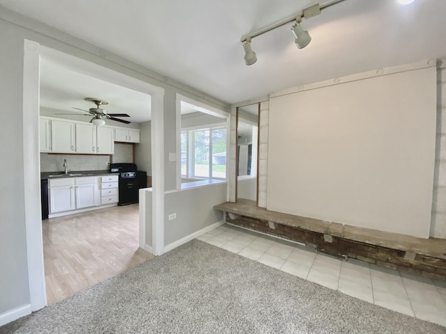 456 Tomahawk St, Park Forest, IL 60466 - spare room featuring light carpet, track lighting, a ceiling fan, and light tile patterned flooring