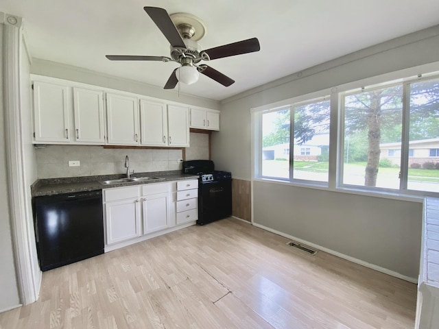 456 Tomahawk St, Park Forest, IL 60466 - kitchen featuring black appliances, dark countertops, light wood finished floors, and white cabinets