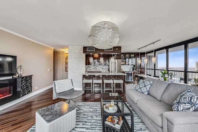 10 E Ontario St Unit 4808, Chicago, IL 60611 - living room with dark wood-style floors, crown molding, a glass covered fireplace, and track lighting