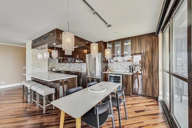 10 E Ontario St Unit 4808, Chicago, IL 60611 - kitchen featuring wine cooler, high end refrigerator, light wood-style floors, tasteful backsplash, and ornamental molding