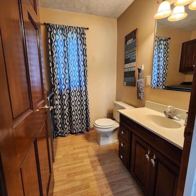 3883 E 2050th Rd, Serena, IL 60549 - full bath with wood finished floors, vanity, and a textured ceiling