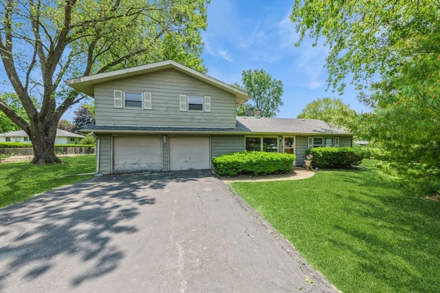 3421 Atlantic Ave, Gurnee, IL 60031 - view of front of house featuring driveway, a front lawn, a garage, and a chimney