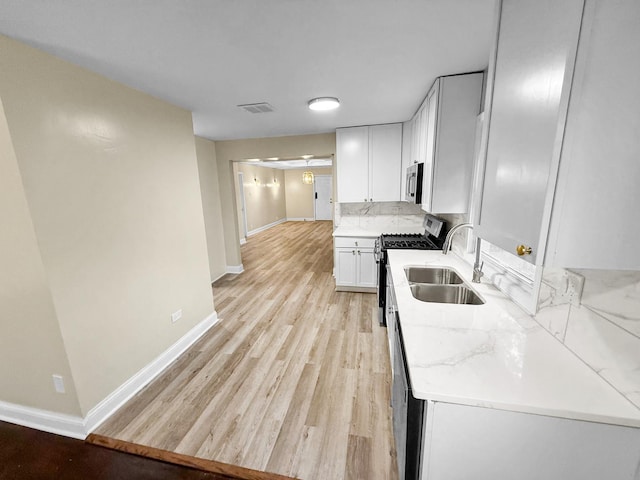16802 Anthony Ave, Hazel Crest, IL 60429 - kitchen with appliances with stainless steel finishes, light wood-style flooring, white cabinetry, and light stone counters