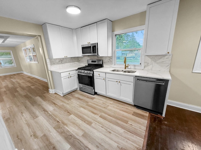 16802 Anthony Ave, Hazel Crest, IL 60429 - kitchen featuring appliances with stainless steel finishes, light wood-style floors, and white cabinetry