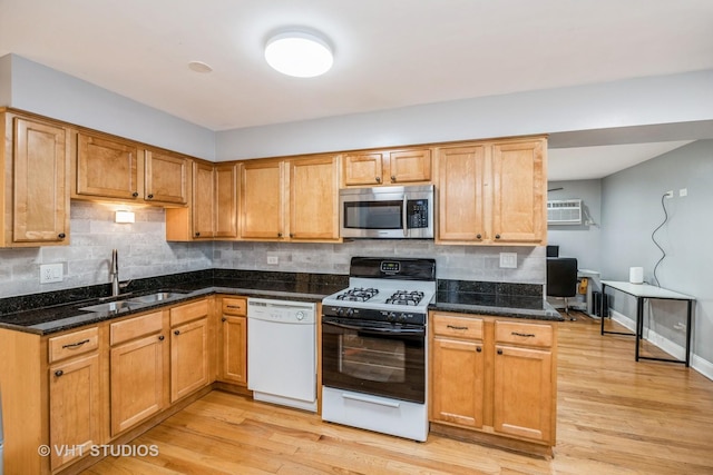 6255 S Mason Ave Unit 1B, Chicago, IL 60638 - kitchen with stainless steel microwave, dishwasher, range with gas cooktop, backsplash, and light wood-type flooring