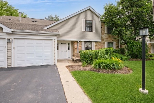371 Southbury Ct Unit B2, Schaumburg, IL 60193 - view of front of home featuring asphalt driveway, stone siding, a front lawn, an attached garage, and a shingled roof