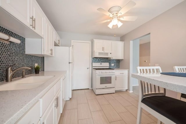 371 Southbury Ct Unit B2, Schaumburg, IL 60193 - kitchen with white appliances, decorative backsplash, ceiling fan, and white cabinetry