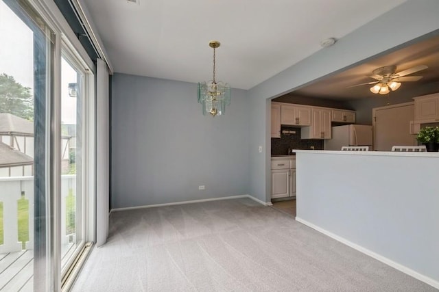 371 Southbury Ct Unit B2, Schaumburg, IL 60193 - kitchen featuring freestanding refrigerator, light carpet, backsplash, a chandelier, and a ceiling fan