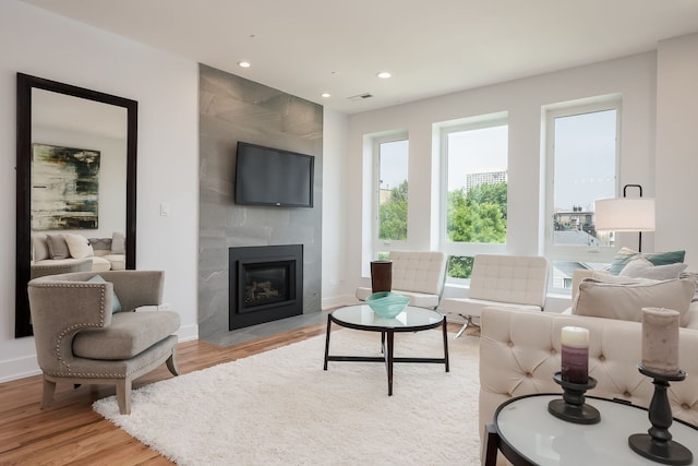 1415 W Walton St Unit 3, Chicago, IL 60642 - living room featuring light wood finished floors, a tiled fireplace, and recessed lighting