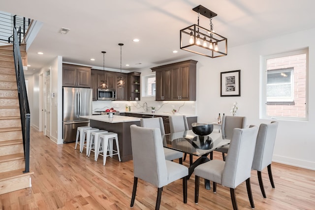 1415 W Walton St Unit 3, Chicago, IL 60642 - dining area with stairs, light wood-style flooring, recessed lighting, and plenty of natural light