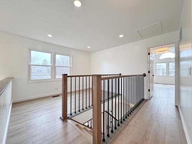 2326 Hamilton Pl, Schaumburg, IL 60194 - hall with an upstairs landing, light wood finished floors, attic access, and recessed lighting