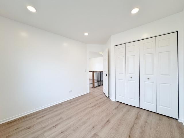 2326 Hamilton Pl, Schaumburg, IL 60194 - unfurnished bedroom with light wood finished floors, a closet, and recessed lighting