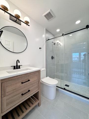 2326 Hamilton Pl, Schaumburg, IL 60194 - bathroom featuring vanity, a shower stall, tile patterned flooring, and recessed lighting