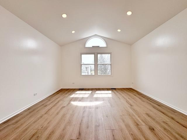 2326 Hamilton Pl, Schaumburg, IL 60194 - spare room featuring lofted ceiling, light wood-type flooring, and recessed lighting