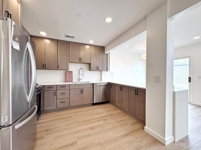 2326 Hamilton Pl, Schaumburg, IL 60194 - kitchen with stainless steel appliances, light wood finished floors, light countertops, and recessed lighting