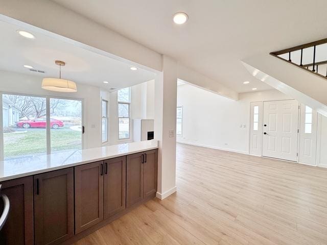 2326 Hamilton Pl, Schaumburg, IL 60194 - kitchen featuring light wood-style flooring, light countertops, open floor plan, decorative light fixtures, and recessed lighting