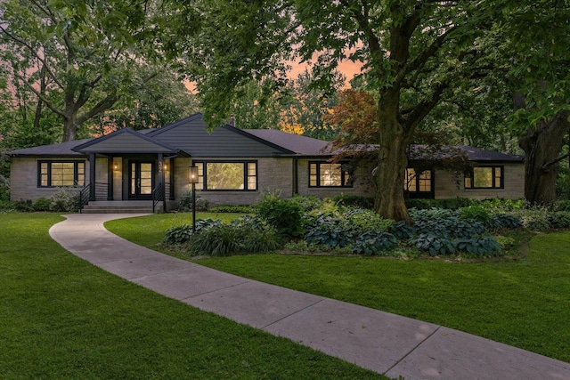 32 Greencroft Dr, Champaign, IL 61821 - mid-century modern home with a lawn and stone siding