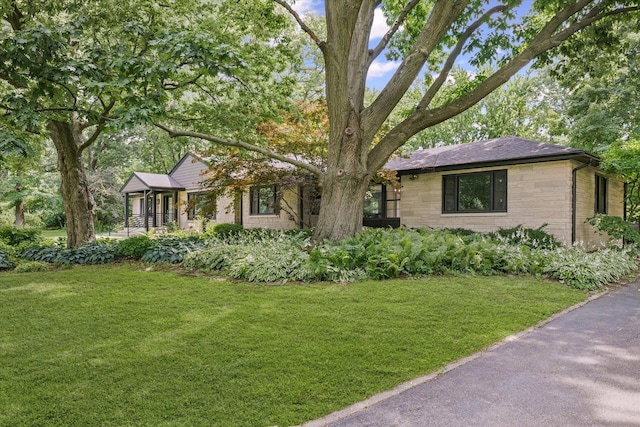 32 Greencroft Dr, Champaign, IL 61821 - ranch-style home with a front lawn and stone siding