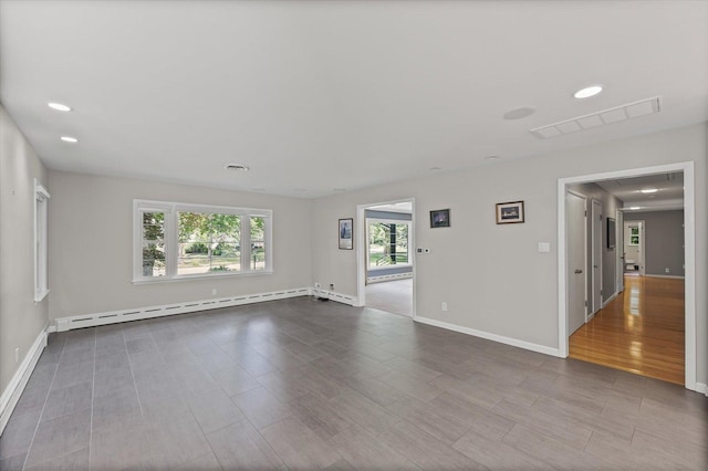 32 Greencroft Dr, Champaign, IL 61821 - spare room featuring baseboard heating, wood finished floors, and recessed lighting