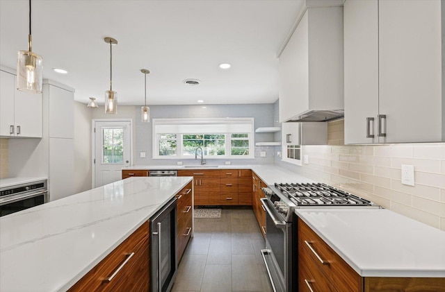 32 Greencroft Dr, Champaign, IL 61821 - kitchen with stainless steel appliances, brown cabinets, tasteful backsplash, wine cooler, and custom exhaust hood