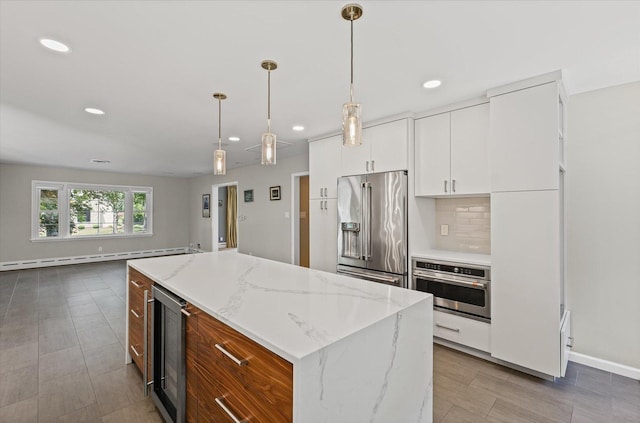32 Greencroft Dr, Champaign, IL 61821 - kitchen with stainless steel appliances, baseboard heating, beverage cooler, recessed lighting, and a center island