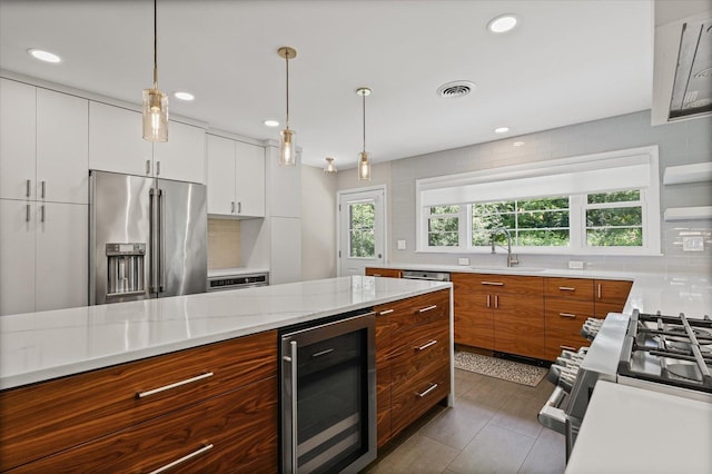 32 Greencroft Dr, Champaign, IL 61821 - kitchen with appliances with stainless steel finishes, beverage cooler, white cabinets, backsplash, and brown cabinets