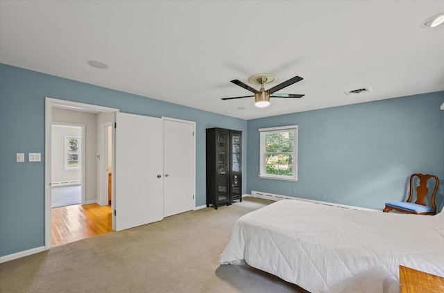 32 Greencroft Dr, Champaign, IL 61821 - bedroom featuring carpet flooring, a ceiling fan, two closets, and baseboard heating