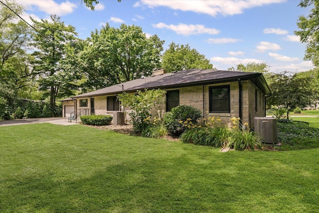 32 Greencroft Dr, Champaign, IL 61821 - single story home with stone siding, a chimney, a front yard, and driveway