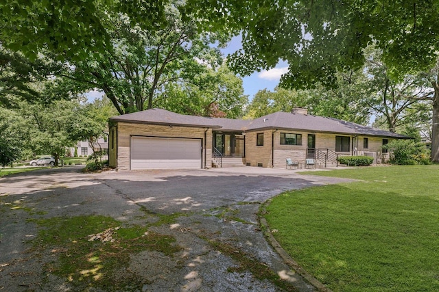 32 Greencroft Dr, Champaign, IL 61821 - ranch-style house featuring an attached garage, a front yard, driveway, a chimney, and brick siding