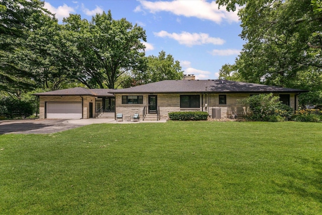 32 Greencroft Dr, Champaign, IL 61821 - ranch-style home featuring entry steps, concrete driveway, an attached garage, a chimney, and stone siding