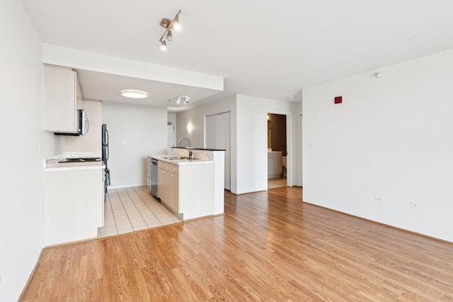 1640 Maple Ave Unit 503, Evanston, IL 60201 - kitchen with stainless steel appliances, light wood-style flooring, light countertops, white cabinetry, and a kitchen island with sink