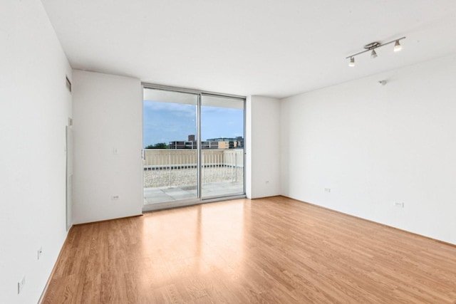 1640 Maple Ave Unit 503, Evanston, IL 60201 - unfurnished room featuring a wall of windows and wood finished floors