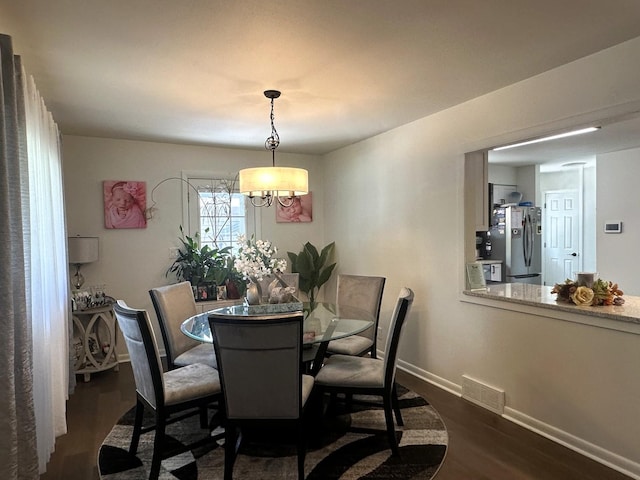 1517 Juniper Ln, Machesney Park, IL 61115 - dining area featuring dark wood-type flooring and baseboards
