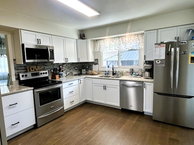 1517 Juniper Ln, Machesney Park, IL 61115 - kitchen featuring stainless steel appliances, white cabinetry, decorative backsplash, and dark wood-type flooring