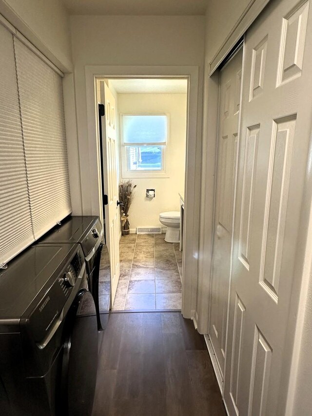 1517 Juniper Ln, Machesney Park, IL 61115 - washroom with washing machine and dryer and dark wood-style flooring