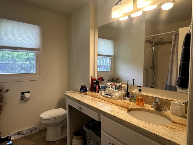 1517 Juniper Ln, Machesney Park, IL 61115 - bathroom featuring healthy amount of natural light, tile patterned floors, a tile shower, and vanity