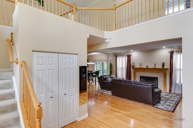 337A Veronica Cir, Bartlett, IL 60103 - living area with a towering ceiling, arched walkways, wood finished floors, stairs, and a tiled fireplace