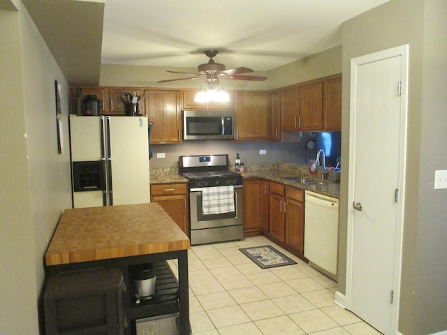 865 N Tamarac Blvd, Addison, IL 60101 - kitchen featuring appliances with stainless steel finishes, light tile patterned floors, a ceiling fan, and brown cabinets
