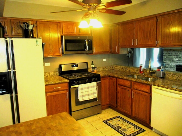 865 N Tamarac Blvd, Addison, IL 60101 - kitchen with appliances with stainless steel finishes, ceiling fan, light tile patterned floors, and dark stone counters