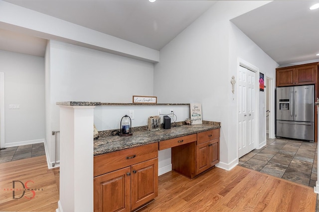 1661 Locust Rd, Morris, IL 60450 - kitchen with stainless steel fridge, brown cabinetry, dark stone counters, light wood-style flooring, and recessed lighting
