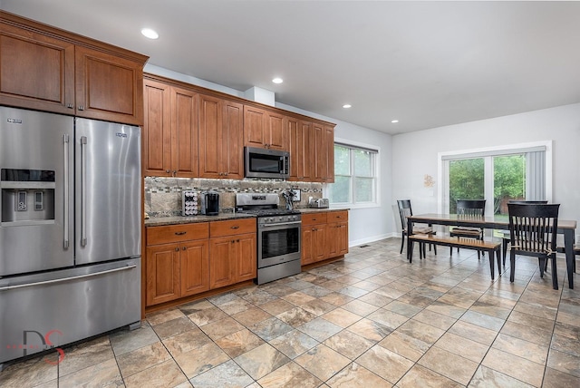 1661 Locust Rd, Morris, IL 60450 - kitchen with appliances with stainless steel finishes, decorative backsplash, brown cabinets, recessed lighting, and light stone finish flooring