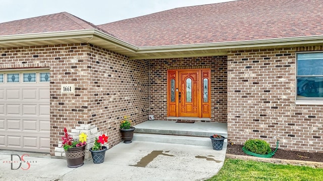 1661 Locust Rd, Morris, IL 60450 - property entrance with brick siding, a shingled roof, and a garage