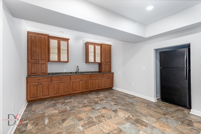1661 Locust Rd, Morris, IL 60450 - kitchen featuring brown cabinets, dark stone finish flooring, glass insert cabinets, and recessed lighting