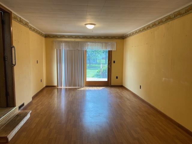 207 N Putnam St, Lostant, IL 61334 - empty room with wood finished floors and baseboards