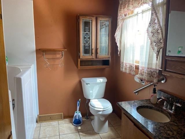 207 N Putnam St, Lostant, IL 61334 - bathroom featuring vanity and tile patterned floors